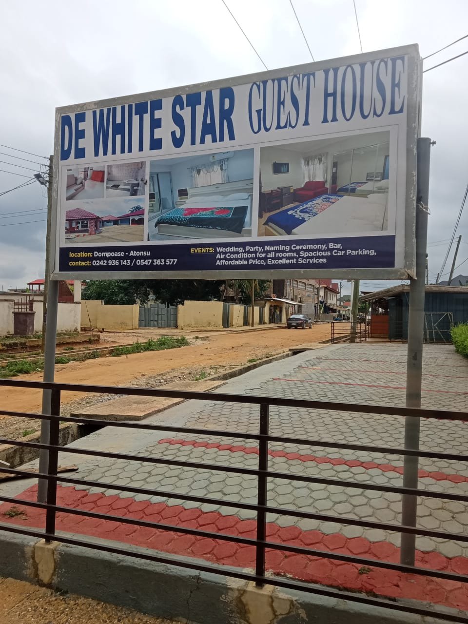 De White Star Guest House signboard showing rooms and facilities